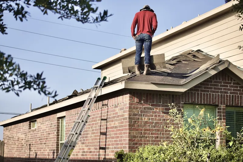 Professional roofer working on a residential roof in Tantic